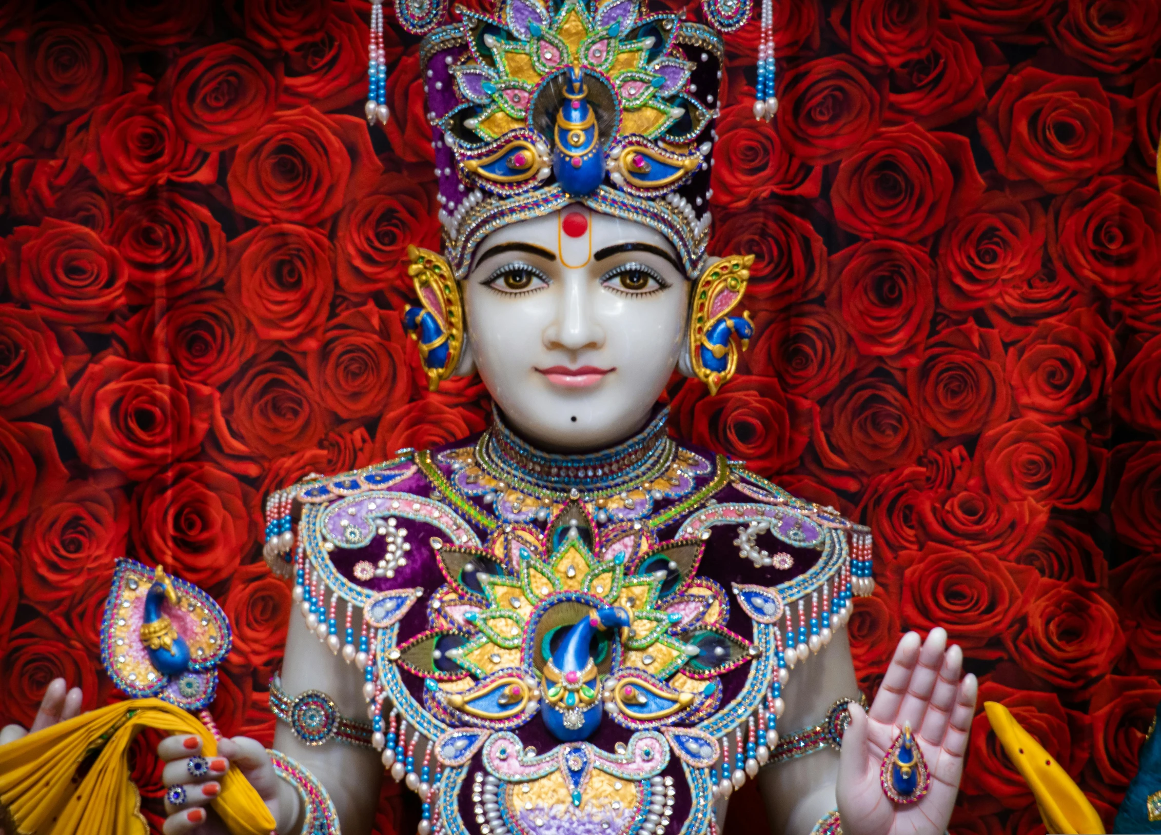 the statue of a hindu god is dressed in bright colors