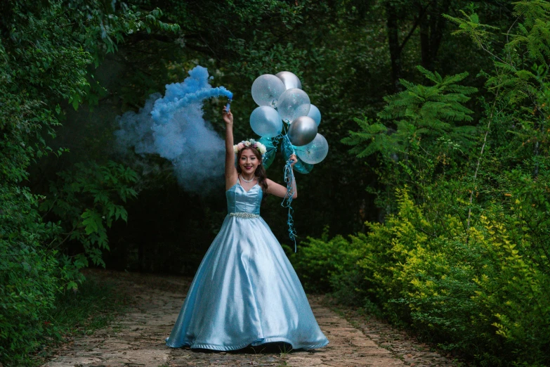 woman in blue gown with balloons on her hand