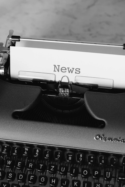 an old fashioned typewriter with news on it