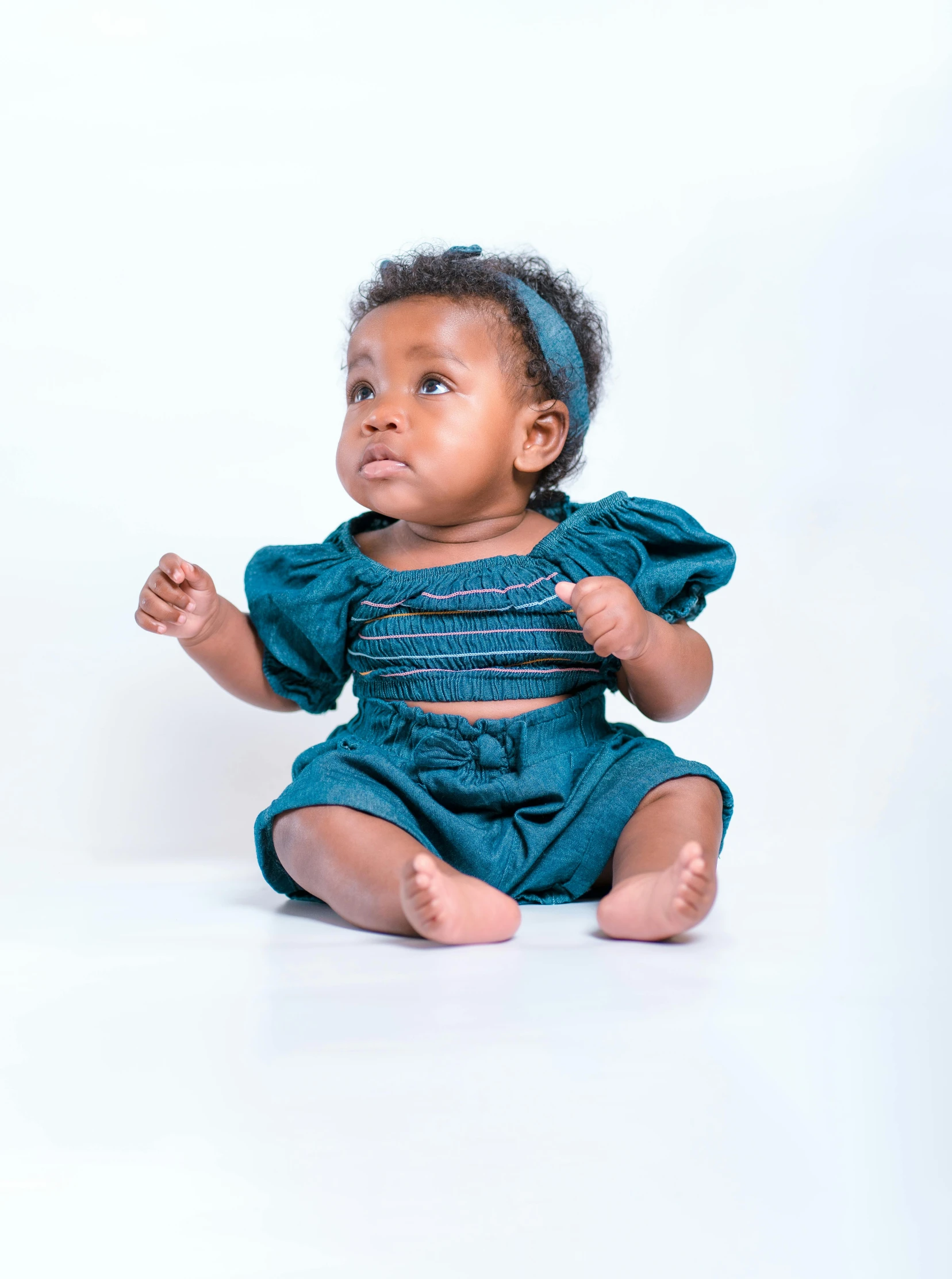 an image of a baby girl sitting down