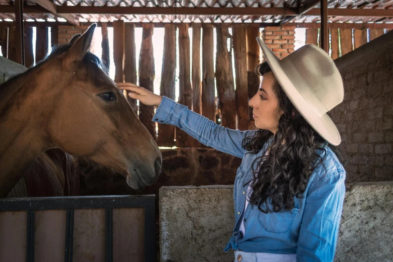 a woman is standing next to a horse