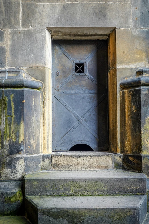 a building with a blue door and steps leading to it