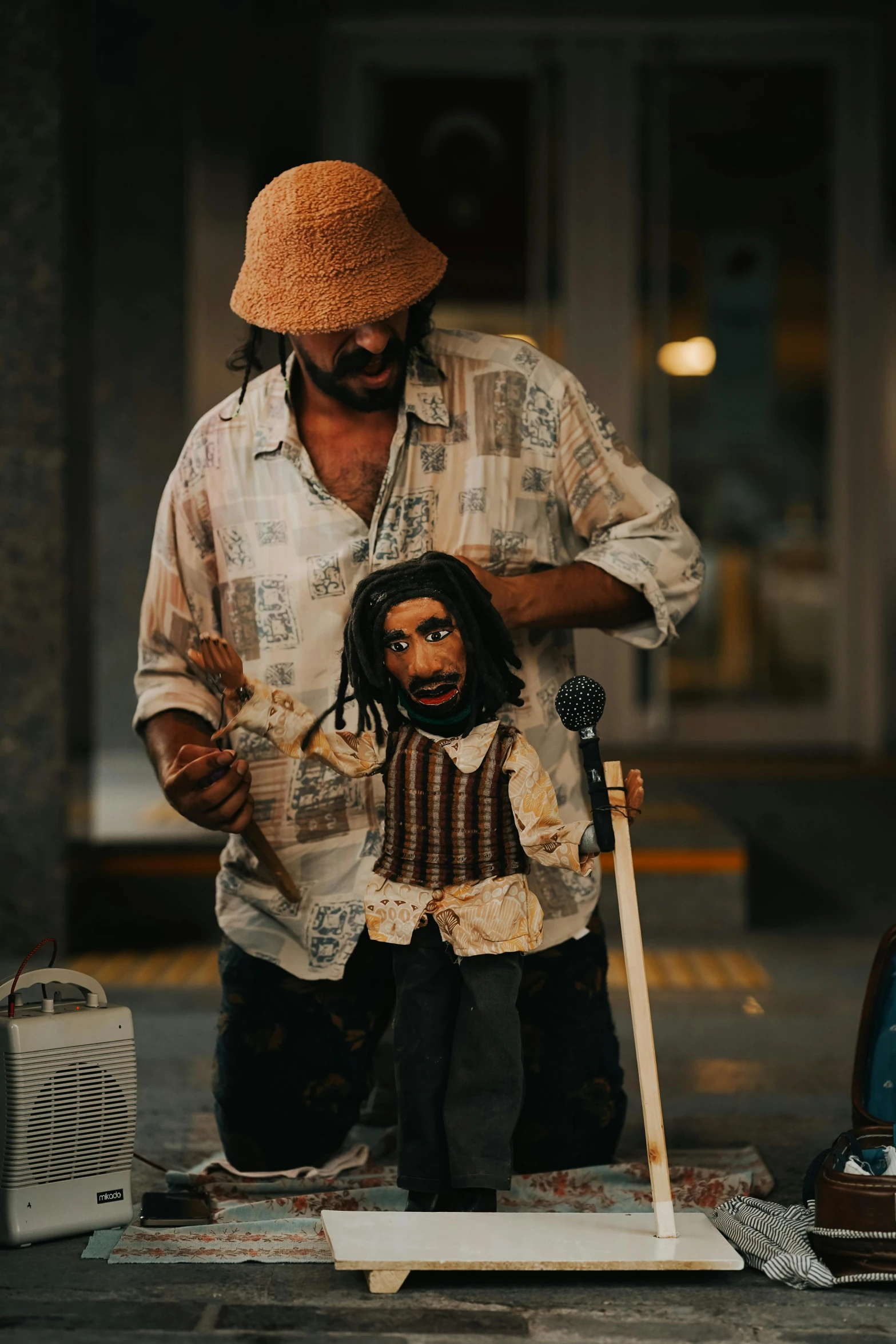 a male street vendor putting a doll on a stick