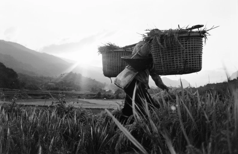 two baskets with hay on them sitting on the ground