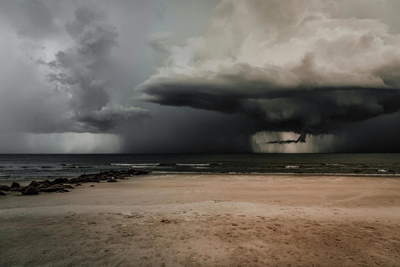 several large dark clouds are on the horizon