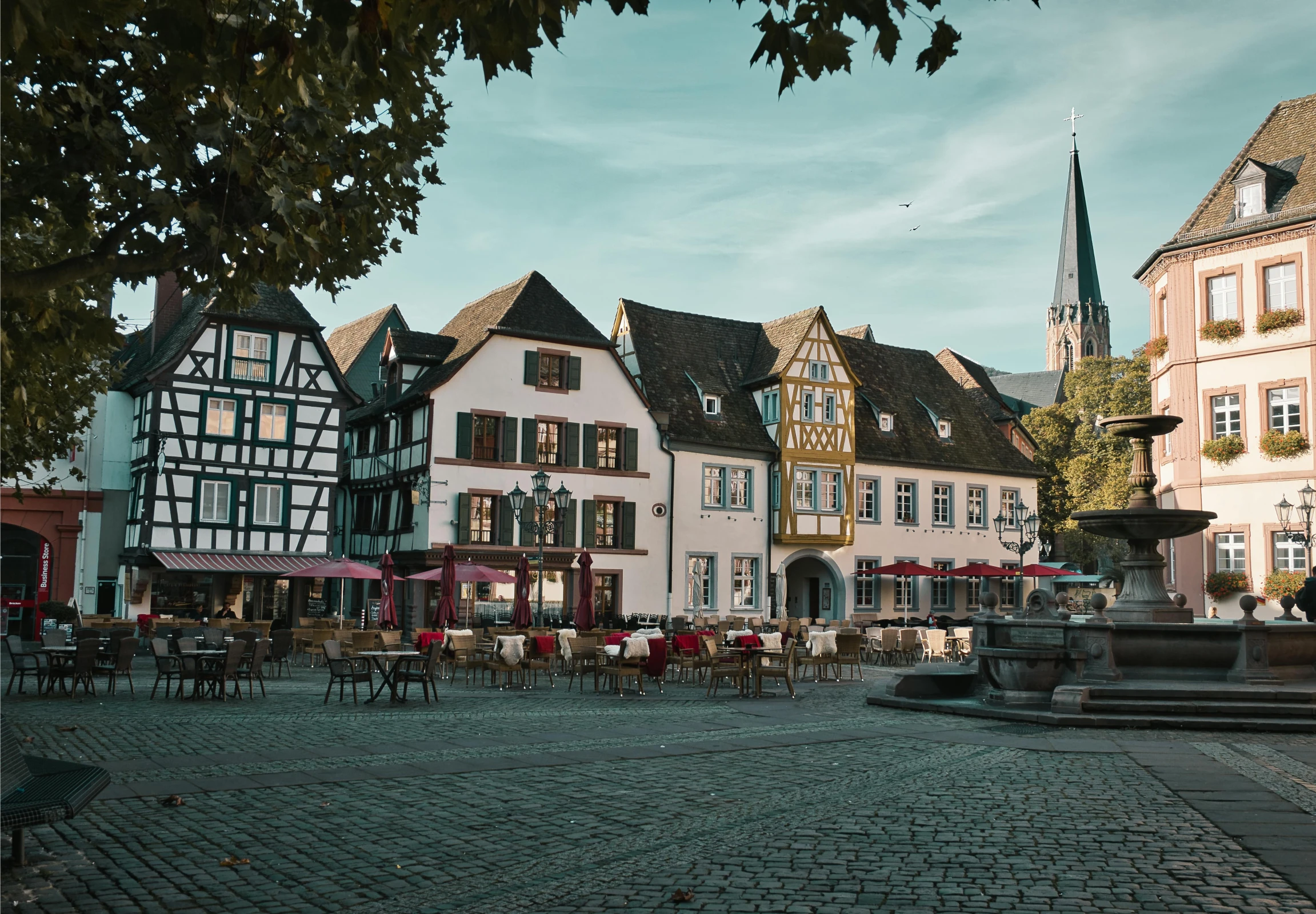 some buildings are next to a water fountain