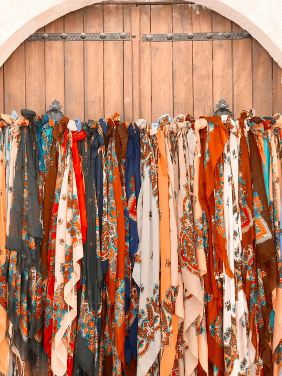 an image of multicolored scarves hanging on display