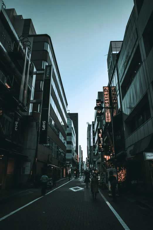 two people walk down a narrow city street