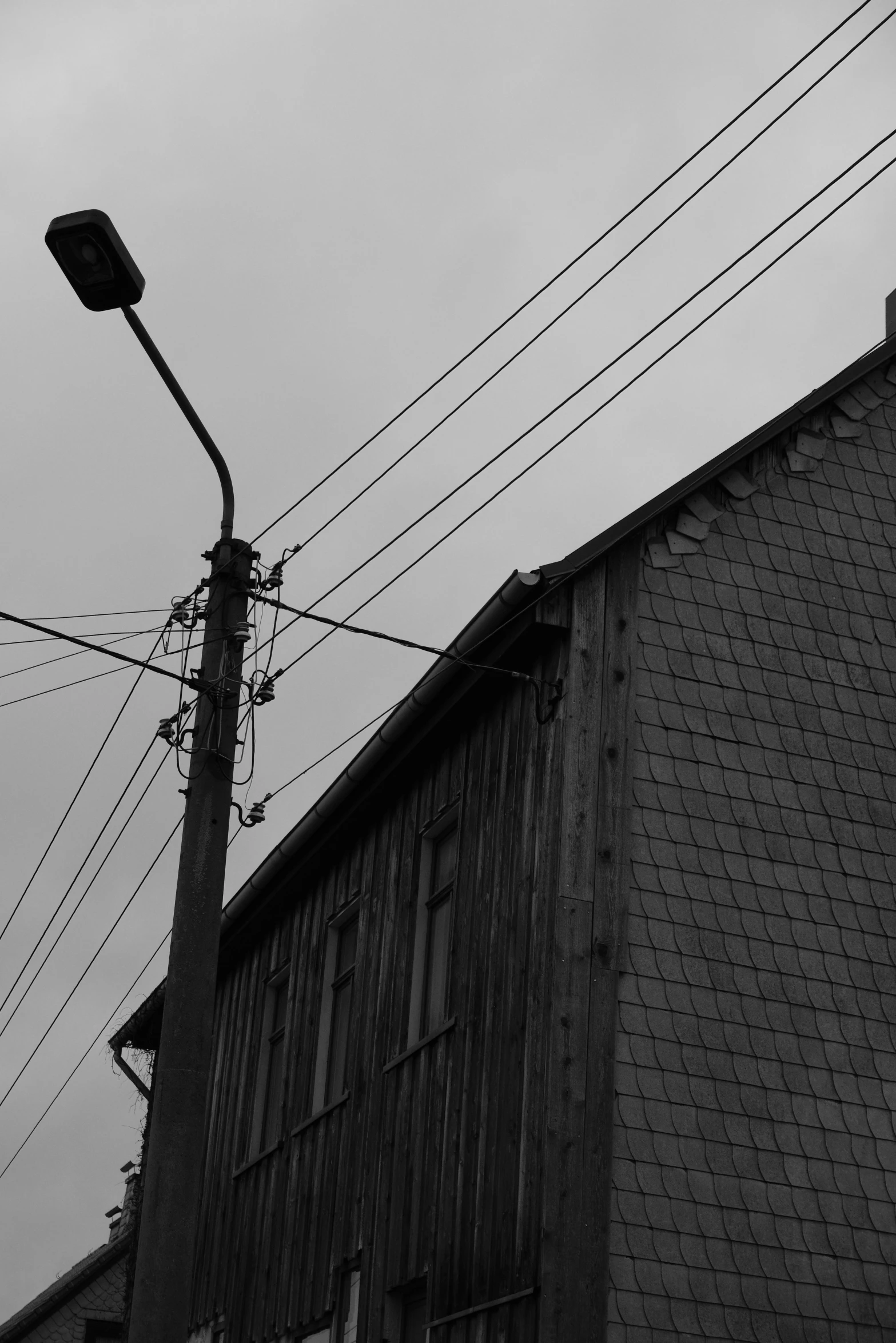 a stoplight sitting next to a building on a cloudy day