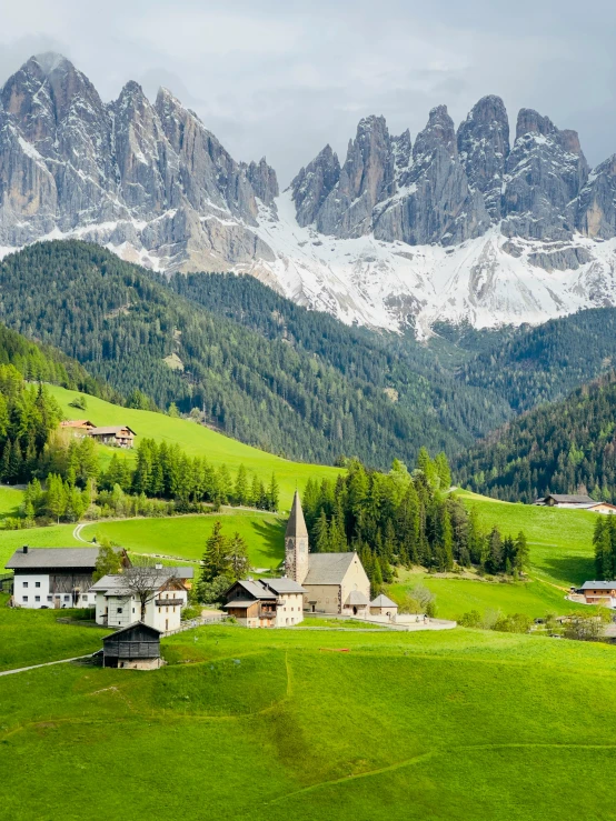 a mountain top with houses nestled in it