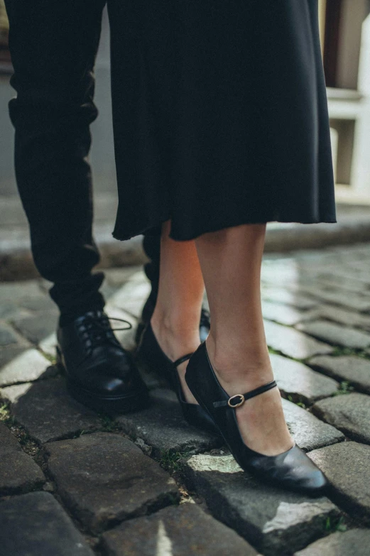 the legs of two people wearing high heel shoes