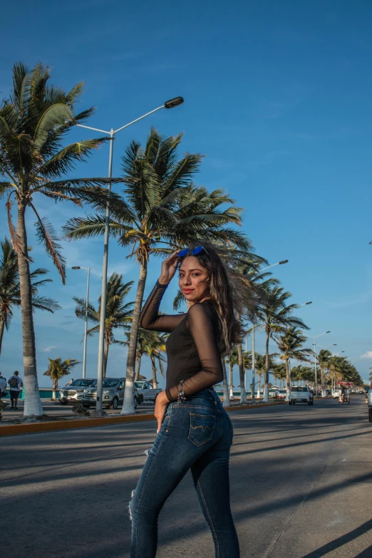 a woman standing in the middle of an empty street