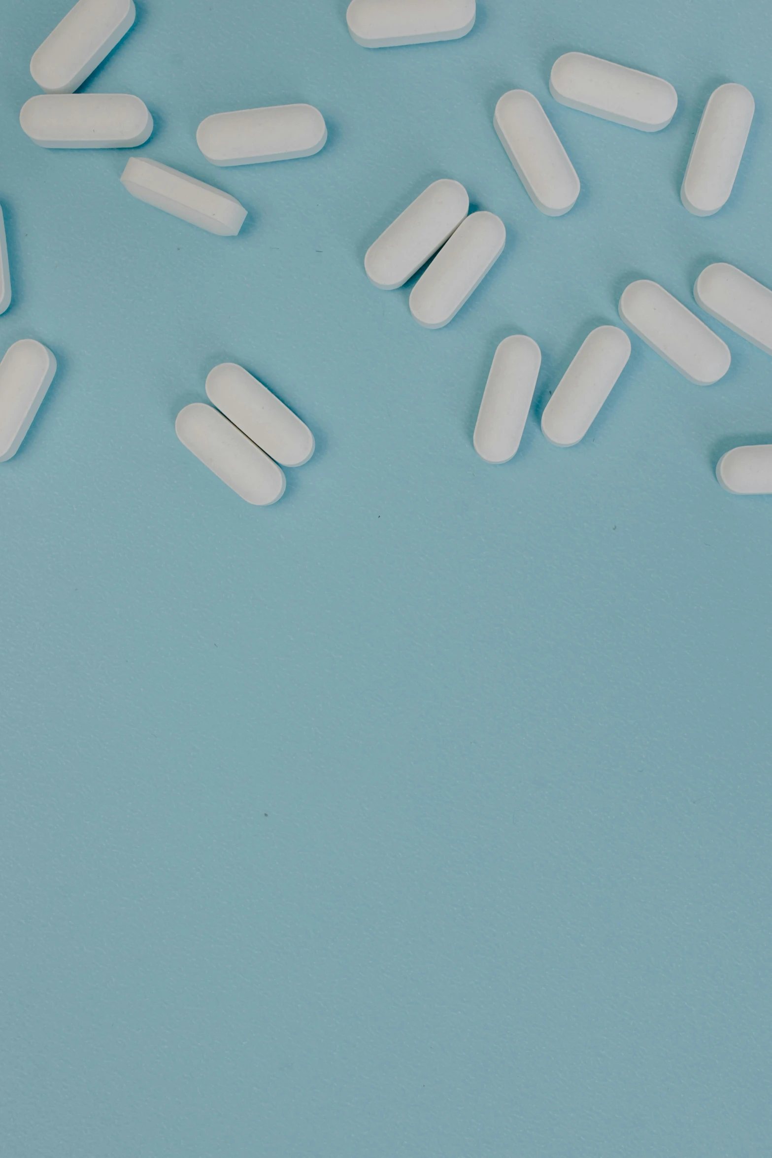 pills placed on a blue surface and laid out on the side