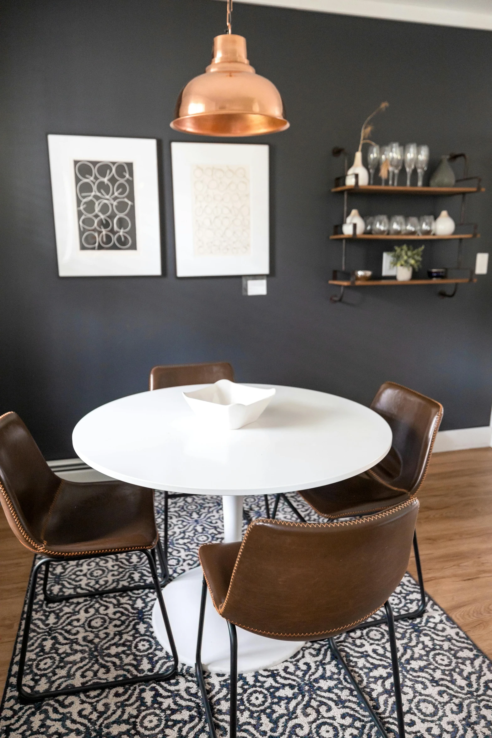 the modern dining room table is white and features black walls