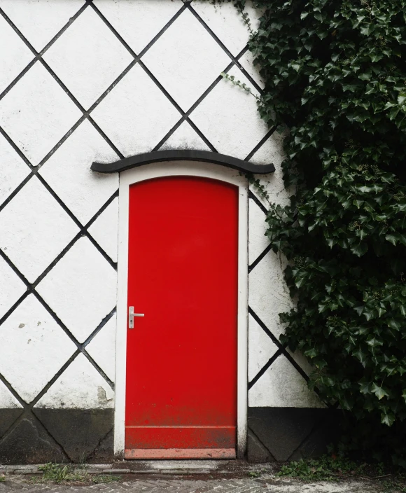 the doorway is painted red and there is a window near it