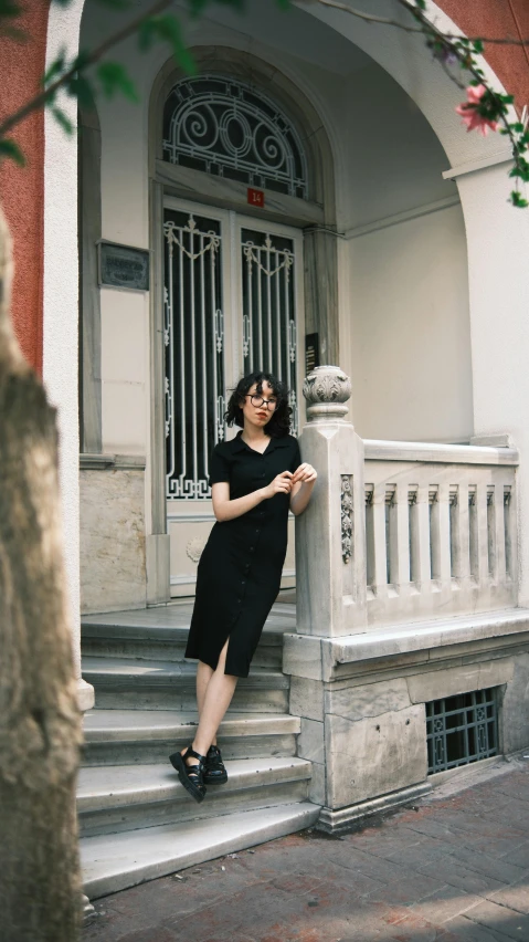 a woman sitting on a porch next to steps