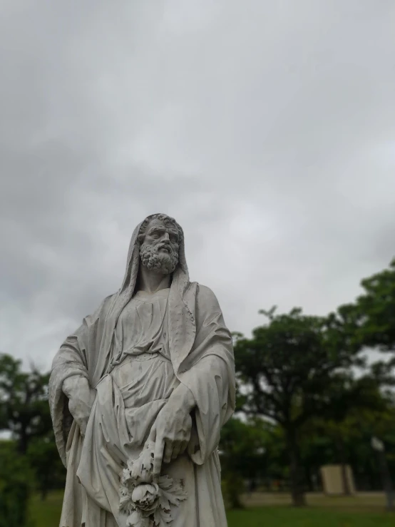 a statue in a park covered in white stuff