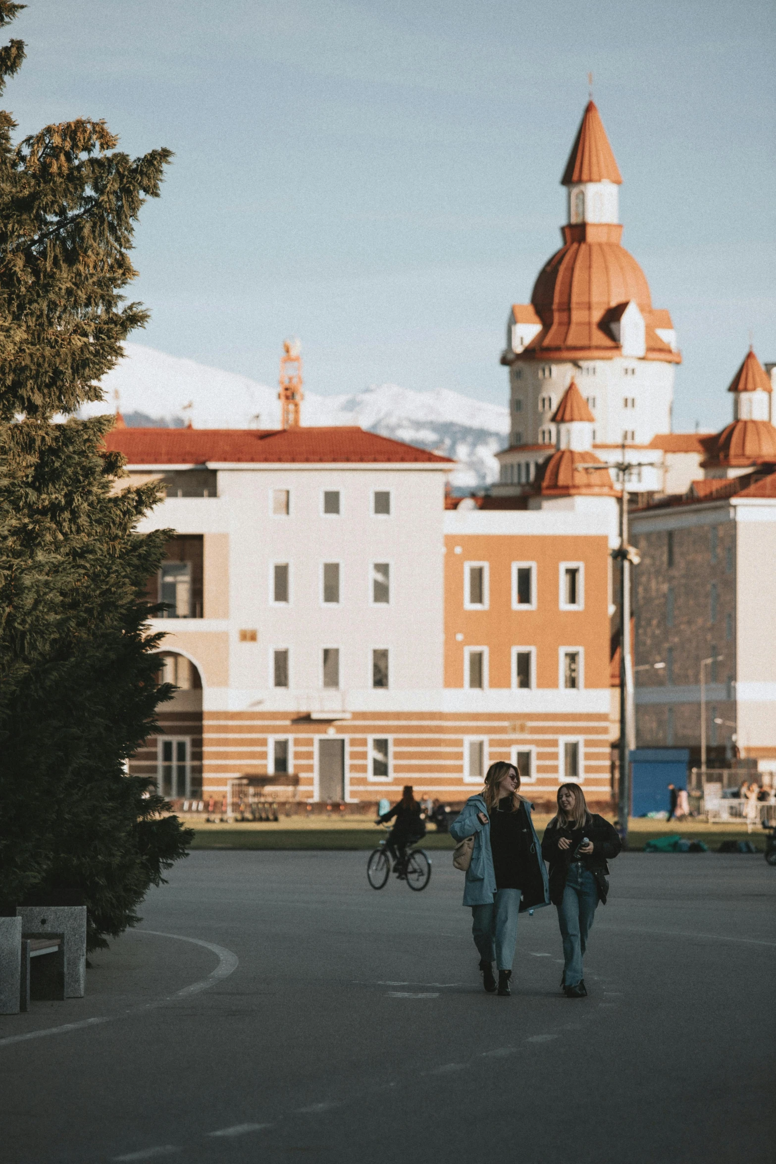 some people walking on the street in front of some buildings