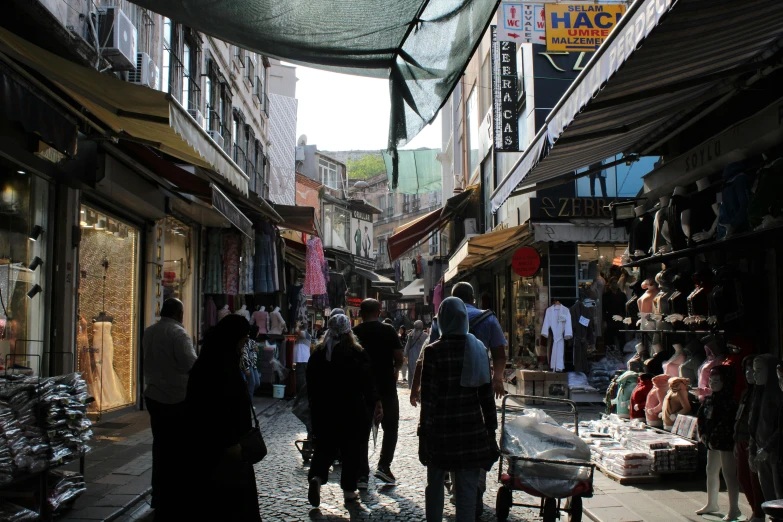 people walking in an outdoor shopping mall while others look on