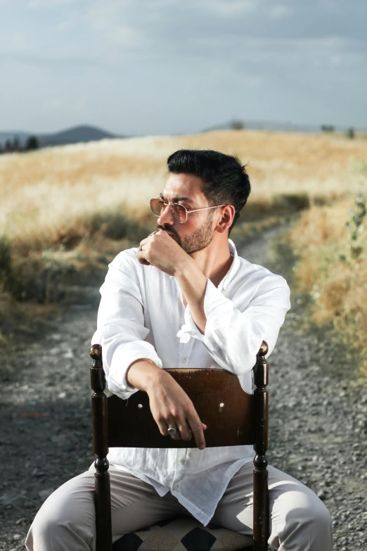 a man sitting in a chair on a trail