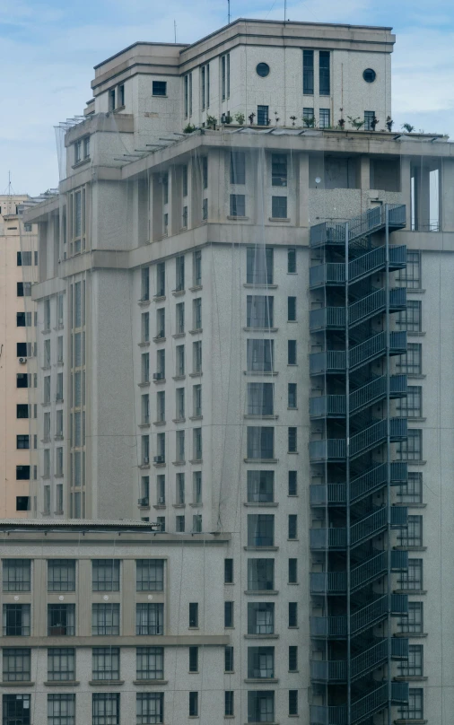 the tall building has balconies on top of it