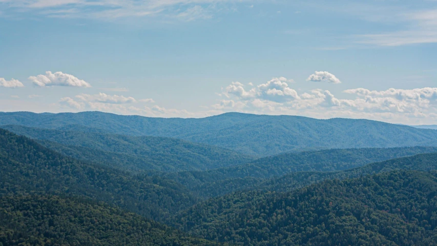 the mountains are tall and lush during the day