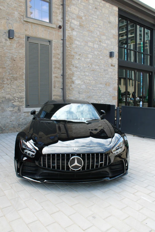 the mercedes s coupe is parked outside a building