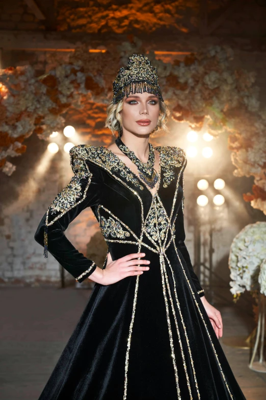 an extravagantly dressed woman in a black dress with gold accents