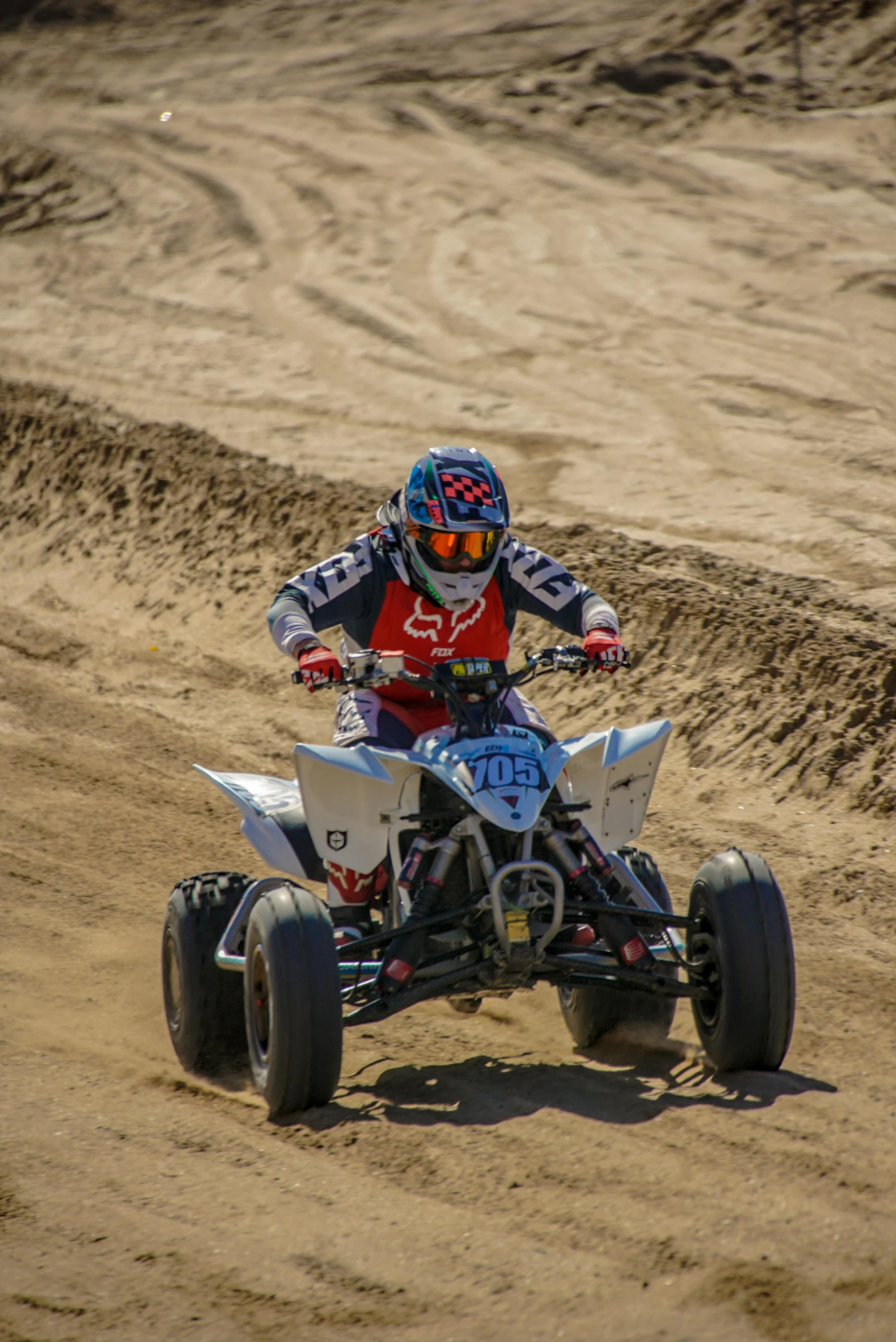 a man is riding a two - wheeled vehicle down a dirt road