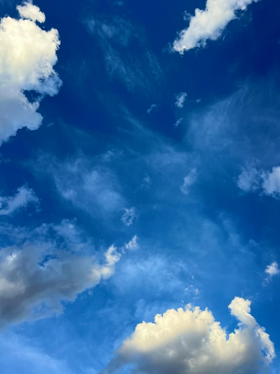 clouds and a jet are flying through the air