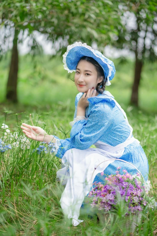 the woman is sitting on the grass and posing for the camera