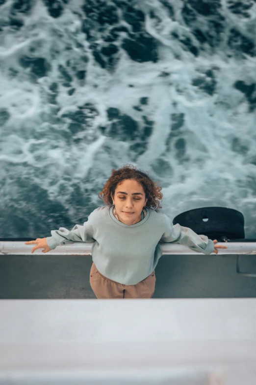 a woman sitting on the deck of a boat