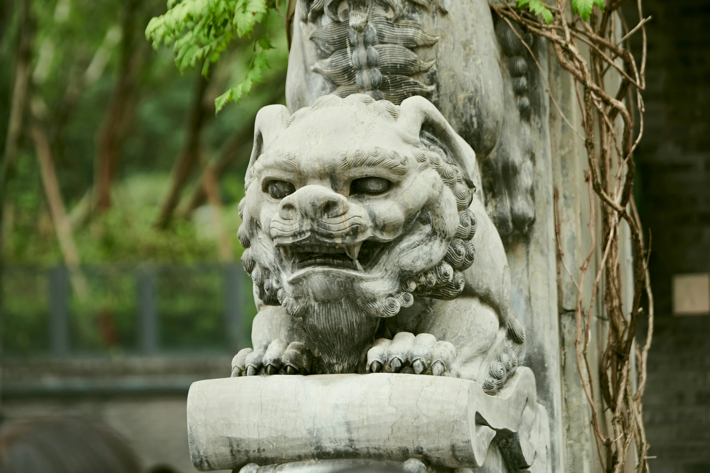 a statue of a lion holding the neck of a bird