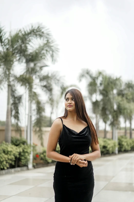 a black woman standing outside and smiling at someone