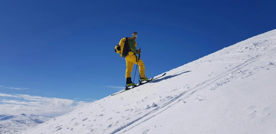 a man riding skis down a snow covered slope