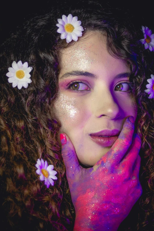 a woman with flowers in her hair poses for a picture