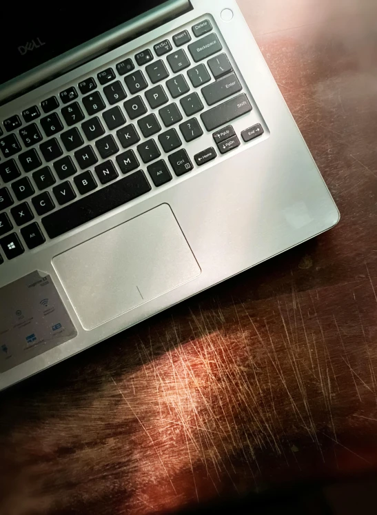 a laptop sitting on top of a wooden table