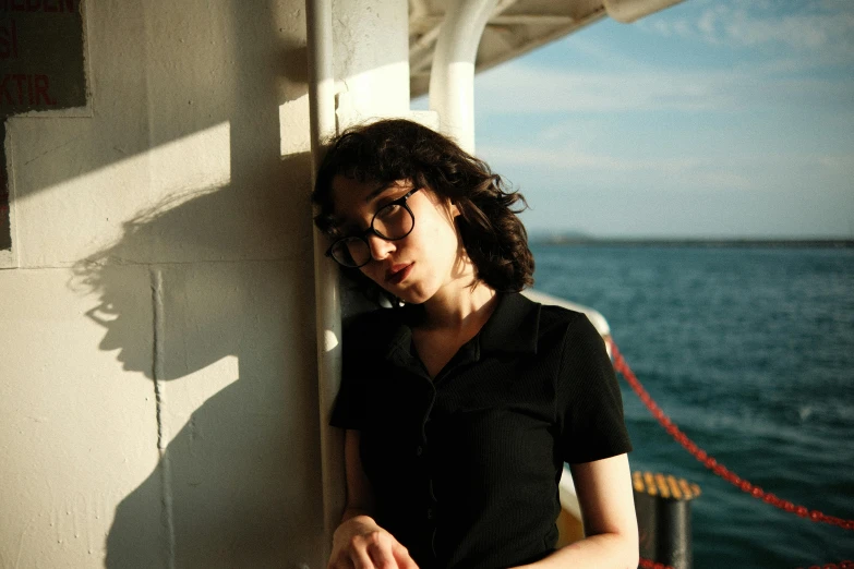 a woman leaning against the wall on a boat