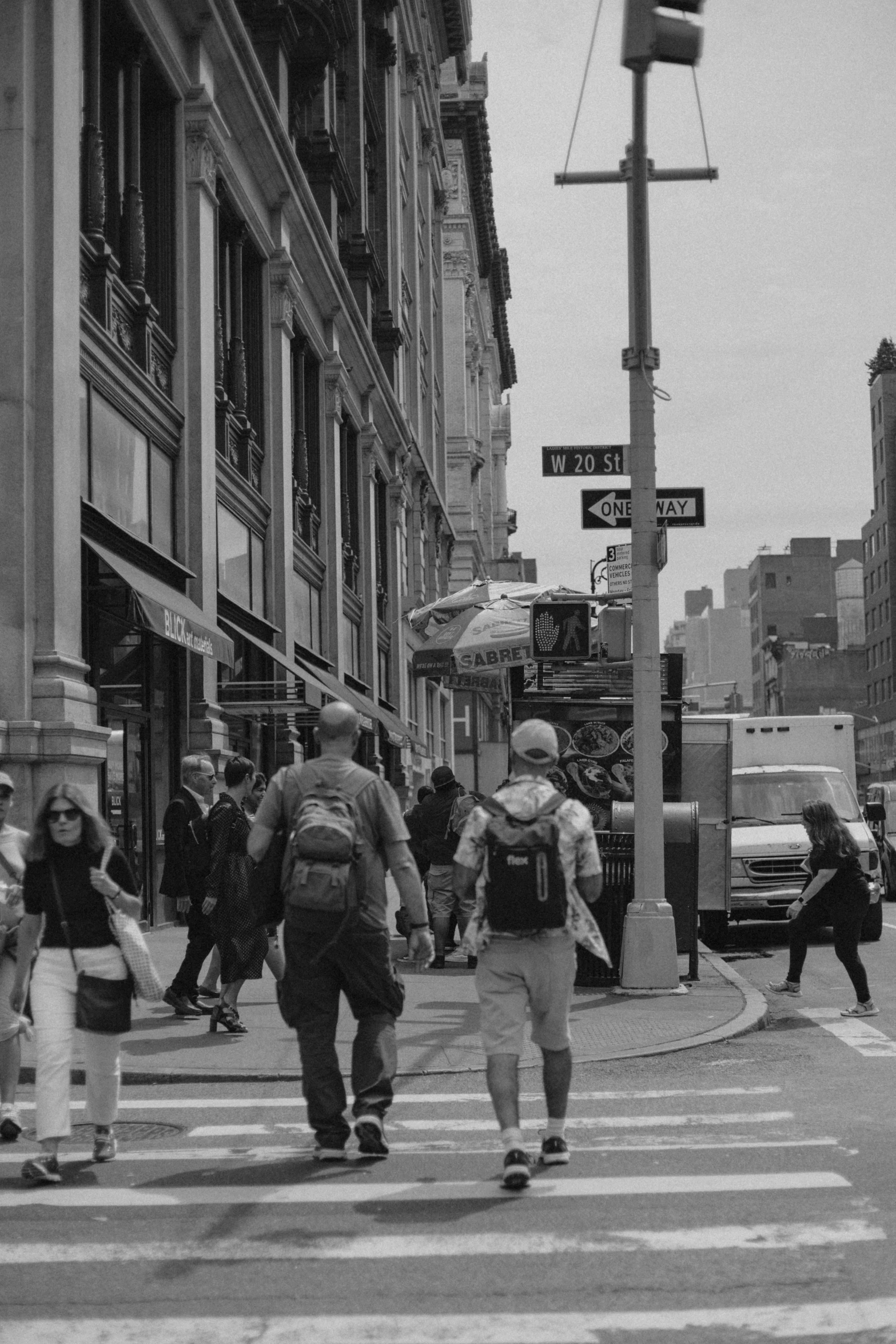 group of people crossing a street near a traffic light