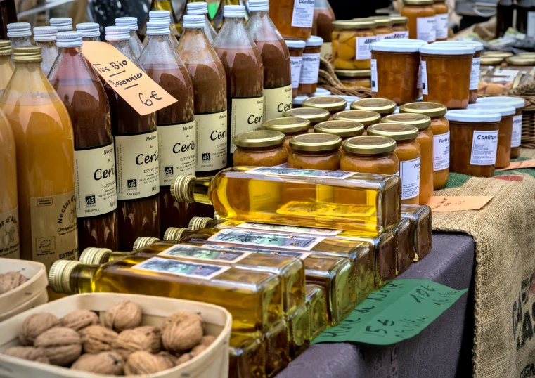 a lot of jars of honey sitting on top of a table