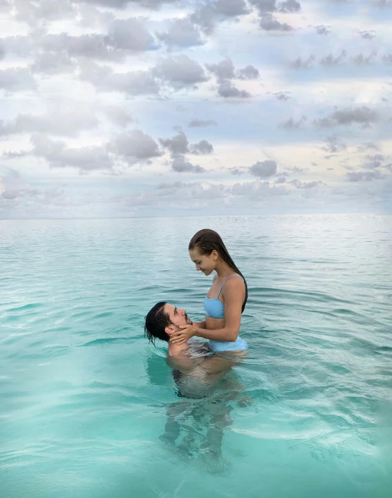 a woman in the water giving her hair brushed