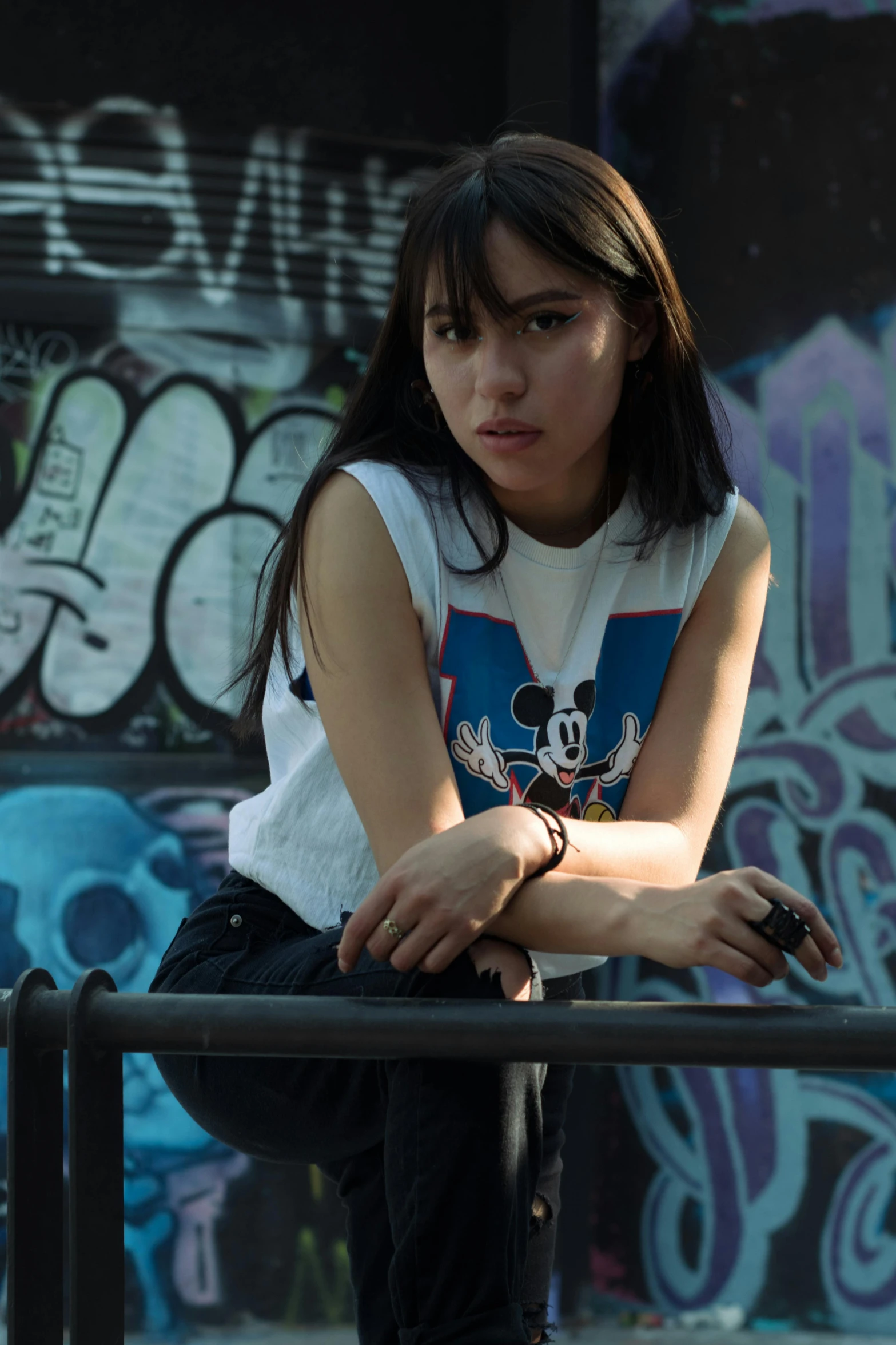 a person standing in front of a wall with graffiti