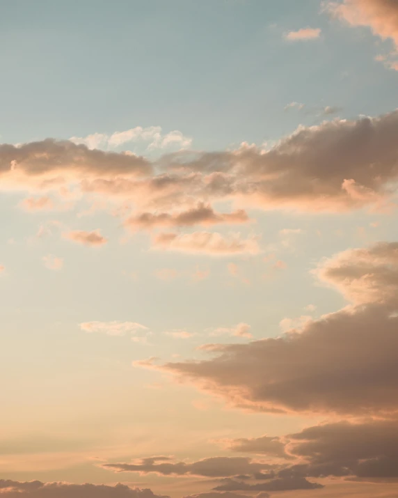 an airplane flying over some clouds in the sky