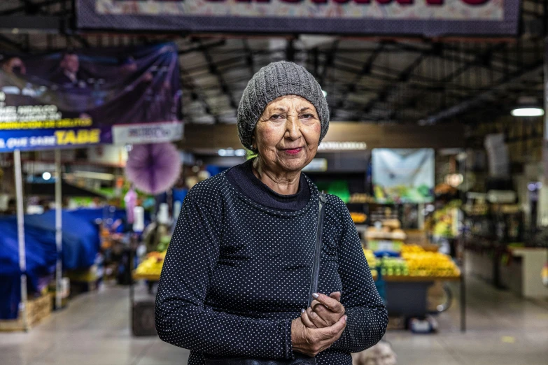 woman smiling while standing in a market