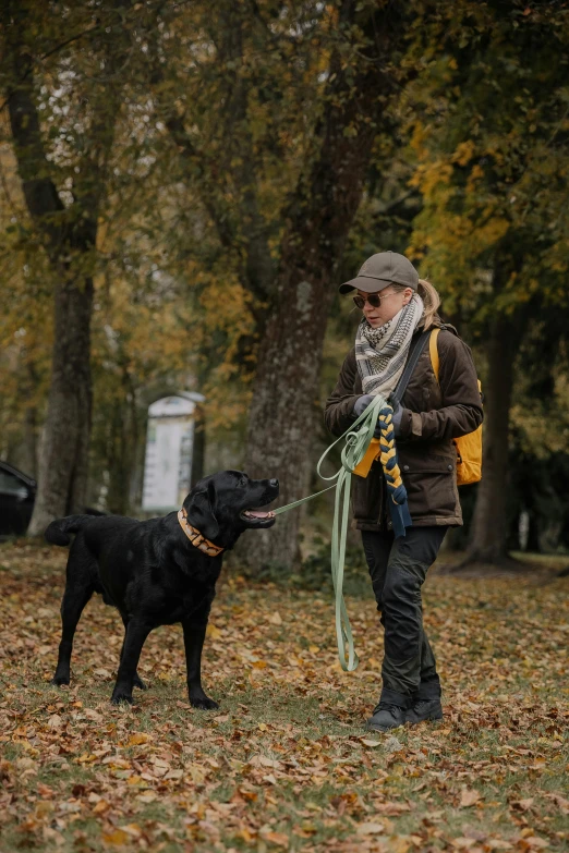 a woman with a dog in a grassy area