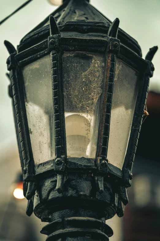 an old style street lamp on the side of a road