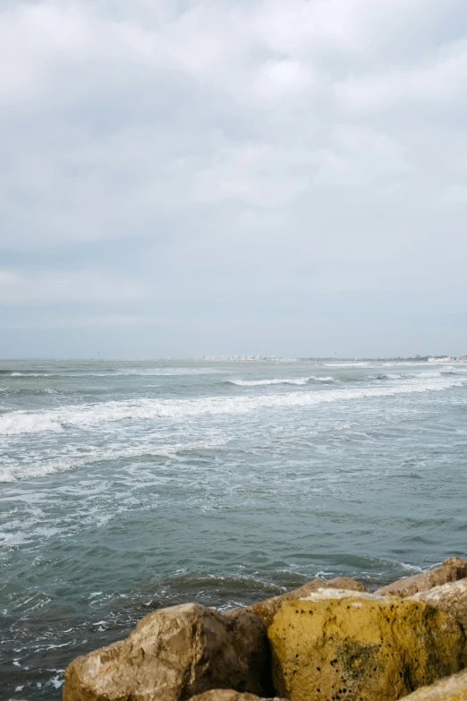 a very big pretty looking body of water by some rocks