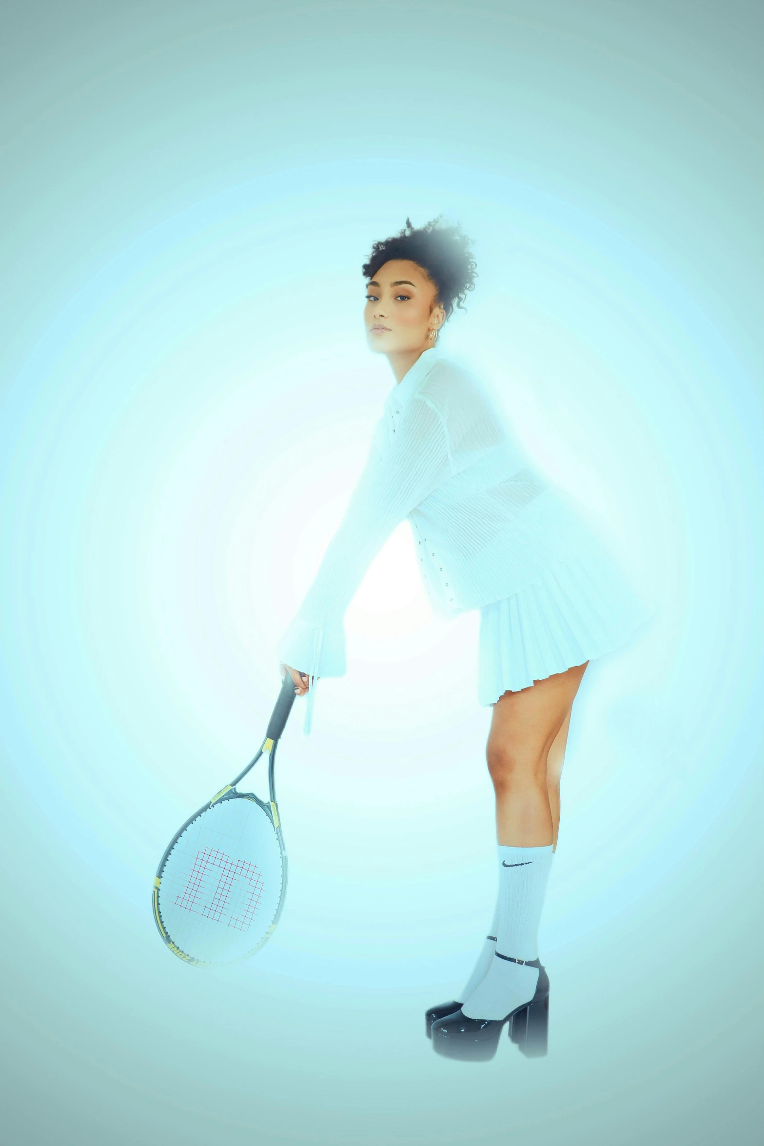 a woman in tight white poses with her racket