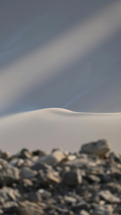 the mountains behind are white as well as grey rocks