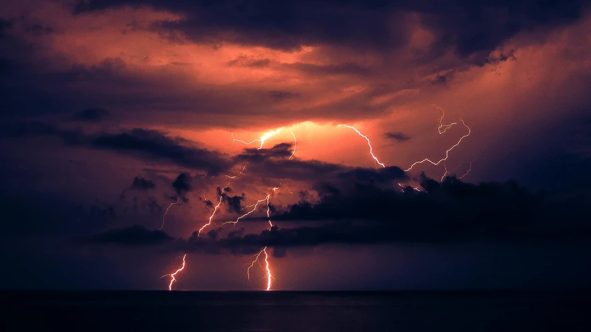 a big cloud with lightning on it is dark